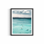 Three surfers paddling through turquoise water at Wategos Beach with Julian Rocks on the horizon — Journey print by Saxon Kent