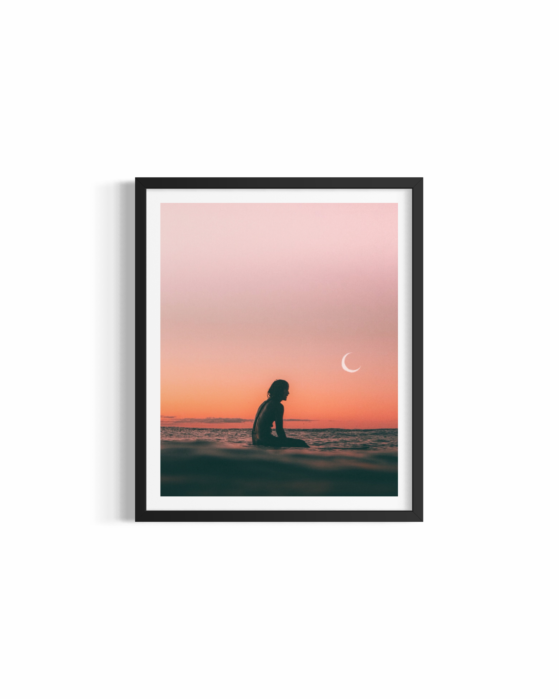 Surfer silhouetted beneath crescent moon at twilight at The Pass Byron Bay — Eclipse fine art print by Saxon Kent