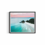 Aerial view of The Pass Byron Bay at golden hour with pastel sky and surfers — The Pass Dreaming print by Saxon Kent