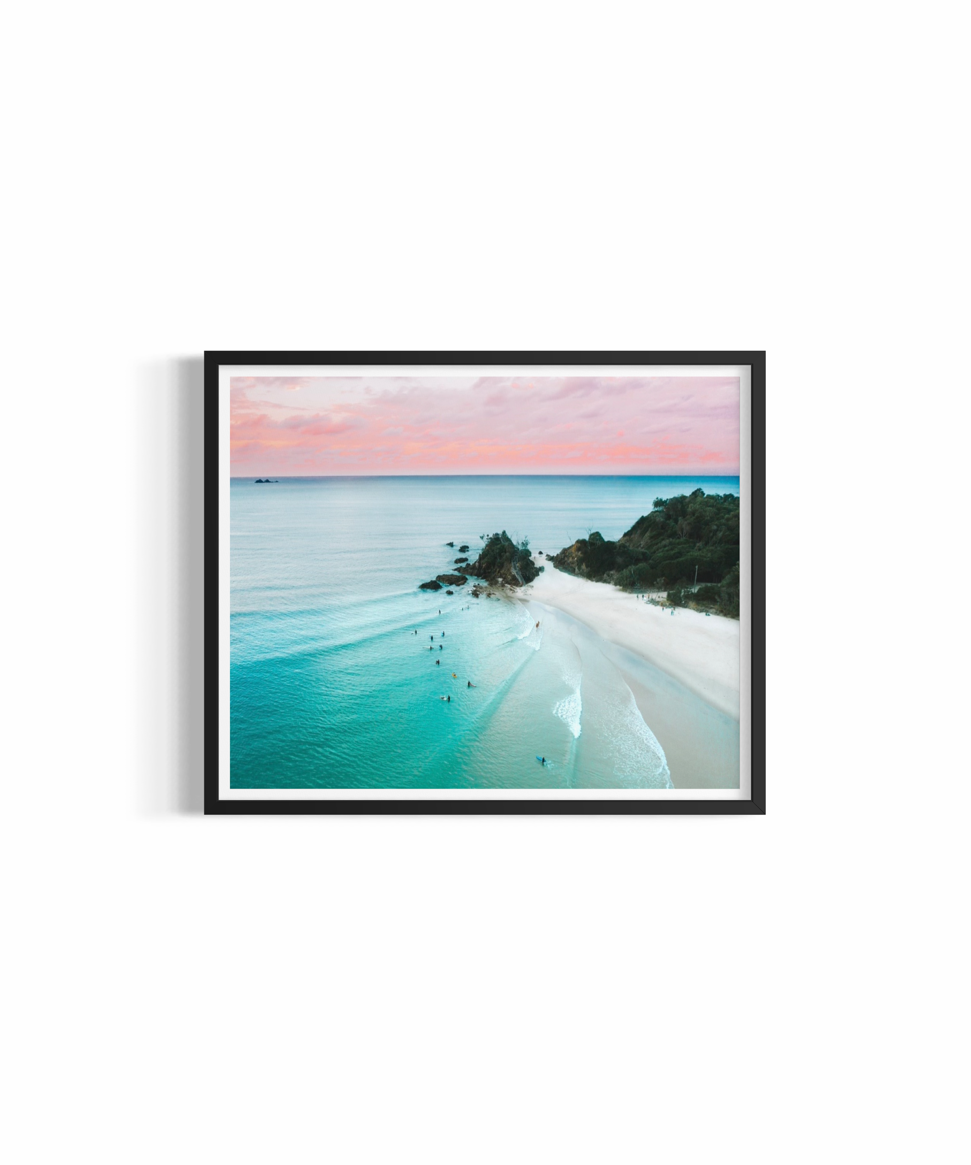 Aerial view of The Pass Byron Bay at golden hour with pastel sky and surfers — The Pass Dreaming print by Saxon Kent
