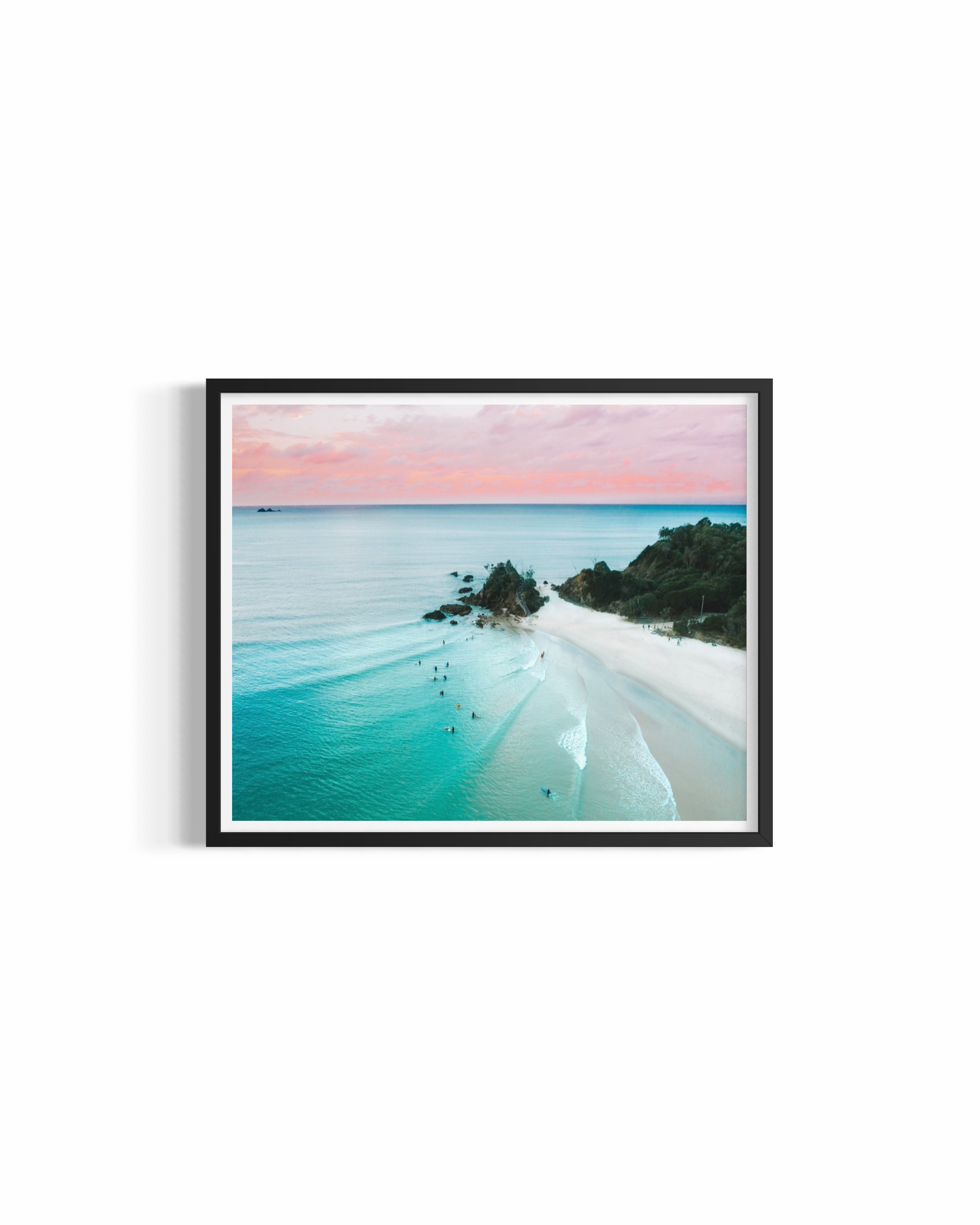 Aerial view of The Pass Byron Bay at golden hour with pastel sky and surfers — The Pass Dreaming print by Saxon Kent