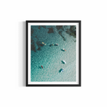 Aerial view of surfers on colourful boards in crystal water at The Pass — 7am on a Sunday print by Saxon Kent