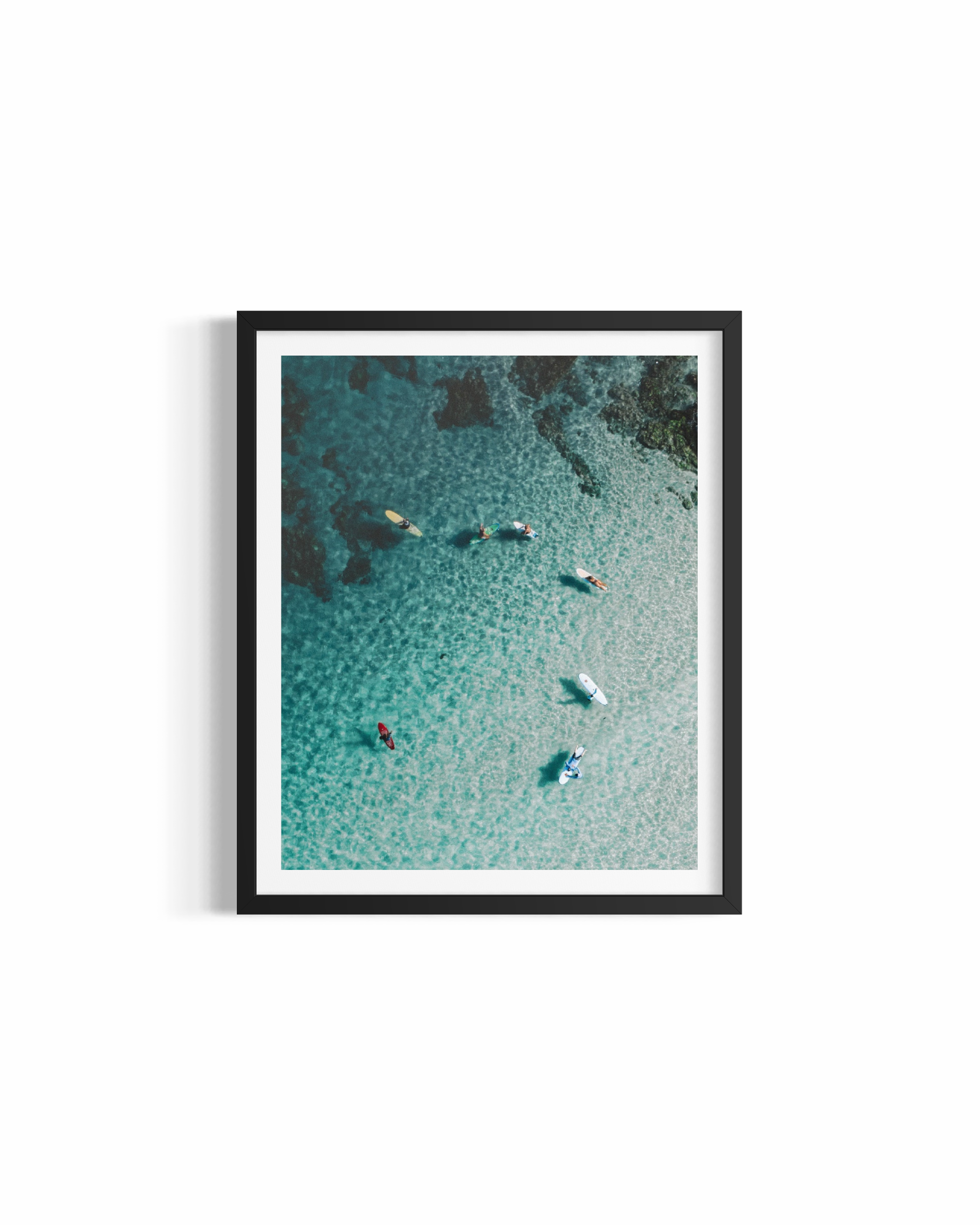 Aerial view of surfers on colourful boards in crystal water at The Pass — 7am on a Sunday print by Saxon Kent