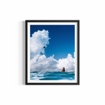 Dreamy figure floating in blue ocean beneath cumulus clouds at Wategos Beach — Attract fine art print by Saxon Kent