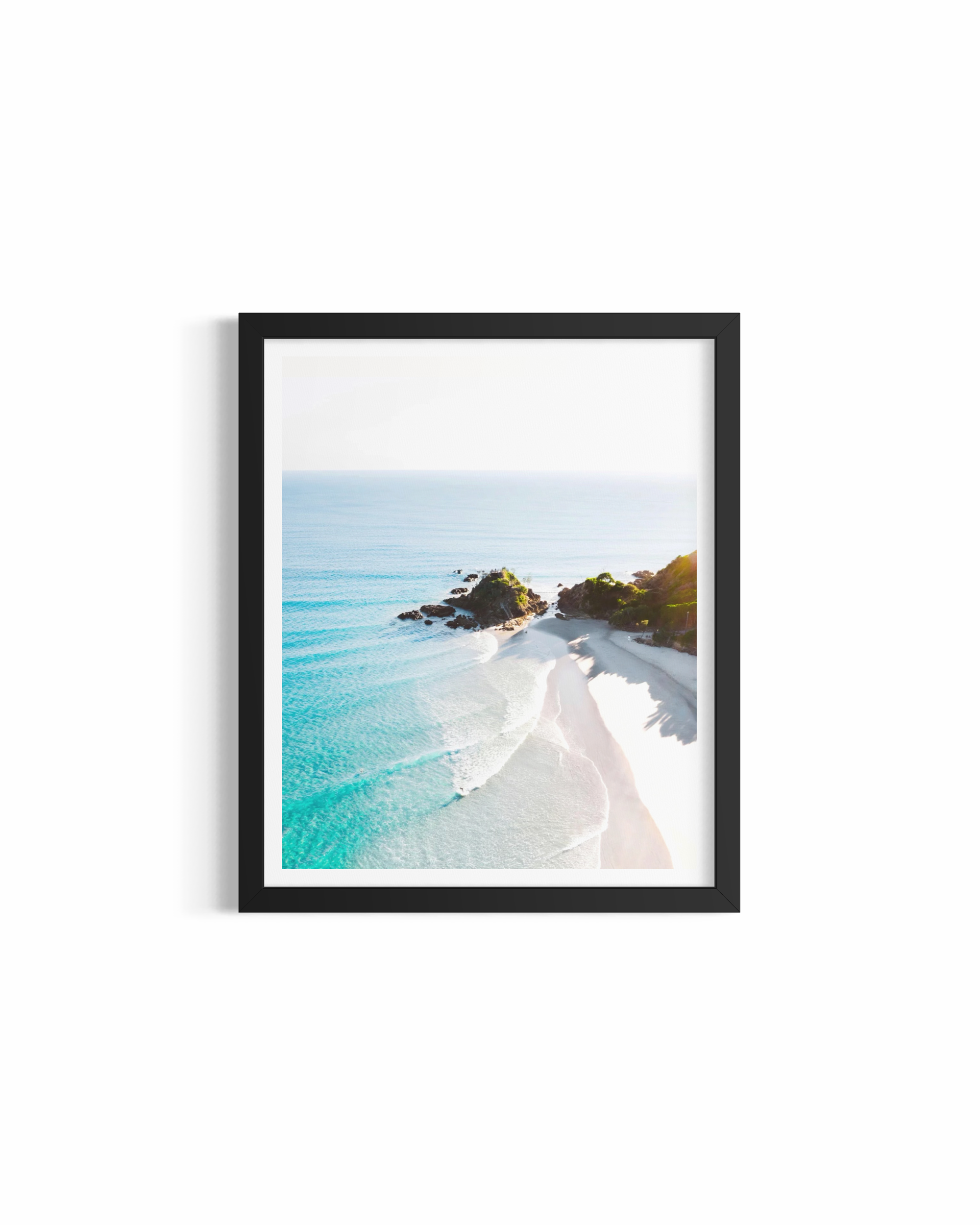 Aerial view of The Pass Byron Bay at sunrise with turquoise water and lone surfer — Morning Glow fine art print by Saxon Kent